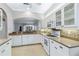 Bright kitchen with white cabinets, granite counters, and stainless steel appliances at 1634 Monarch Dr # 1634, Venice, FL 34293