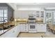 Bright kitchen with white cabinets, granite counters, and stainless steel appliances at 1634 Monarch Dr # 1634, Venice, FL 34293