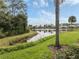 Scenic lake view with lush landscaping and palm trees at 1634 Monarch Dr # 1634, Venice, FL 34293