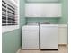 Laundry room with washer, dryer, cabinets, and window at 1634 Monarch Dr # 1634, Venice, FL 34293