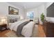 Main bedroom with plush bed, wood floors, and accent chairs at 1634 Monarch Dr # 1634, Venice, FL 34293