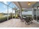 Relaxing screened patio with lake view, table and chairs at 1634 Monarch Dr # 1634, Venice, FL 34293