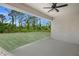 Covered patio overlooking a spacious backyard with lush greenery at 18055 Dublin Ave, Port Charlotte, FL 33948