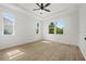 Bright bedroom with tile floors and ceiling fan at 18055 Dublin Ave, Port Charlotte, FL 33948