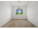 Simple dining room with light walls, wood-look tile floors, and a chandelier at 18055 Dublin Ave, Port Charlotte, FL 33948