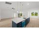Open concept kitchen with island, stainless steel appliances, and tile floors at 18055 Dublin Ave, Port Charlotte, FL 33948