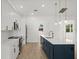 Modern kitchen with white cabinets, blue island, and quartz countertops at 18055 Dublin Ave, Port Charlotte, FL 33948