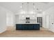 Modern kitchen with white cabinets, blue island, and quartz countertops at 18055 Dublin Ave, Port Charlotte, FL 33948