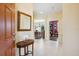 Inviting foyer with tile flooring, mirror, and table, leading to the dining area and other rooms in the home at 1841 Batello Dr, Venice, FL 34292