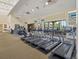 A community gym featuring treadmills, television monitors, and windows for natural light at 1841 Batello Dr, Venice, FL 34292