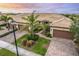 Aerial view of three-unit villa building, showing landscaping and driveway at 18891 Lanuvio St, Venice, FL 34293