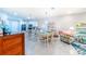 Open concept dining area with white table and chairs, adjacent to kitchen at 18891 Lanuvio St, Venice, FL 34293