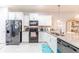 Well-equipped kitchen featuring granite countertops and white cabinets at 18891 Lanuvio St, Venice, FL 34293
