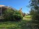 Landscaped backyard with a view of neighboring homes at 1890 San Trovaso Way, Venice, FL 34285