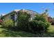 Landscaped backyard with flowering plants and a screened enclosure at 1890 San Trovaso Way, Venice, FL 34285
