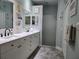 Elegant bathroom featuring dual sinks and a frameless shower at 1890 San Trovaso Way, Venice, FL 34285
