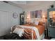 Spacious bedroom with burnt orange comforter and decorative cabinets at 1890 San Trovaso Way, Venice, FL 34285
