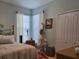 Serene bedroom with a metal bed frame and two windows at 1890 San Trovaso Way, Venice, FL 34285