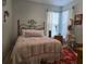 Cozy bedroom with a metal bed frame and a charming atmosphere at 1890 San Trovaso Way, Venice, FL 34285