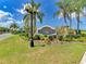 Pelican Pointe Golf & Country Club entrance with lush landscaping and palm trees at 1890 San Trovaso Way, Venice, FL 34285