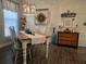 Farmhouse-style dining room with a rustic wooden table, chandelier, and decorative wall accents at 1890 San Trovaso Way, Venice, FL 34285