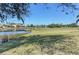 Peaceful golf course view with calm water and homes at 1890 San Trovaso Way, Venice, FL 34285