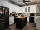 Modern kitchen with white cabinets and a kitchen island at 1890 San Trovaso Way, Venice, FL 34285