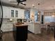 Modern kitchen with white cabinets, island, and breakfast bar at 1890 San Trovaso Way, Venice, FL 34285