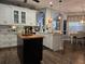 Modern kitchen with white cabinets, island, and breakfast bar at 1890 San Trovaso Way, Venice, FL 34285