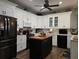 Modern kitchen with white cabinets and a kitchen island at 1890 San Trovaso Way, Venice, FL 34285