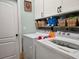 Functional laundry room with washer, dryer, and storage at 1890 San Trovaso Way, Venice, FL 34285