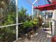 Lush, screened patio with brick pavers and various plants at 1890 San Trovaso Way, Venice, FL 34285