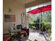 Inviting patio with a bistro set and red umbrella at 1890 San Trovaso Way, Venice, FL 34285