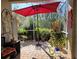 Relaxing screened patio with brick pavers and red umbrella at 1890 San Trovaso Way, Venice, FL 34285