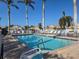 Inviting community pool with lounge chairs and palm trees at 1890 San Trovaso Way, Venice, FL 34285