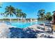 Community pool with patio furniture and lush landscaping at 1890 San Trovaso Way, Venice, FL 34285
