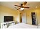 Bedroom with a queen bed, TV, and spacious closet at 1953 Settlement Rd # 14, Venice, FL 34285