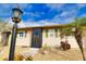 Tan house with green shutters, landscaping, and a walkway at 1953 Settlement Rd # 14, Venice, FL 34285
