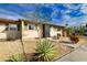 Tan house with green shutters, landscaping, and a walkway at 1953 Settlement Rd # 14, Venice, FL 34285
