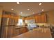 Stainless steel appliances and wood cabinets in open concept kitchen at 1953 Settlement Rd # 14, Venice, FL 34285