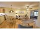 Spacious living area with hardwood floors, comfortable seating, and access to screened patio at 1953 Settlement Rd # 14, Venice, FL 34285