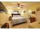 Bright main bedroom featuring a king-size bed and ensuite bathroom at 1953 Settlement Rd # 14, Venice, FL 34285