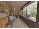 Relaxing screened porch with seating area and dining table at 1953 Settlement Rd # 14, Venice, FL 34285