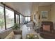 Enclosed sunroom with seating area and dining table, offering ample space at 1953 Settlement Rd # 14, Venice, FL 34285