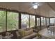 Bright and airy sunroom with wicker furniture and views of the backyard at 1953 Settlement Rd # 14, Venice, FL 34285