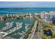 Aerial view of Sarasota Bayfront, featuring a marina, waterfront homes, and a bridge at 2020 Harbourside Dr # 424, Longboat Key, FL 34228