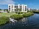 Condo building with private dock and lush landscaping at 2020 Harbourside Dr # 424, Longboat Key, FL 34228