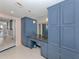 Bathroom with blue vanity, granite countertop, and walk-in shower at 2020 Harbourside Dr # 424, Longboat Key, FL 34228