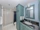 Guest bathroom with blue vanity and shower/tub combo at 2020 Harbourside Dr # 424, Longboat Key, FL 34228