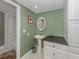 Bathroom with pedestal sink and white vanity at 2020 Harbourside Dr # 424, Longboat Key, FL 34228